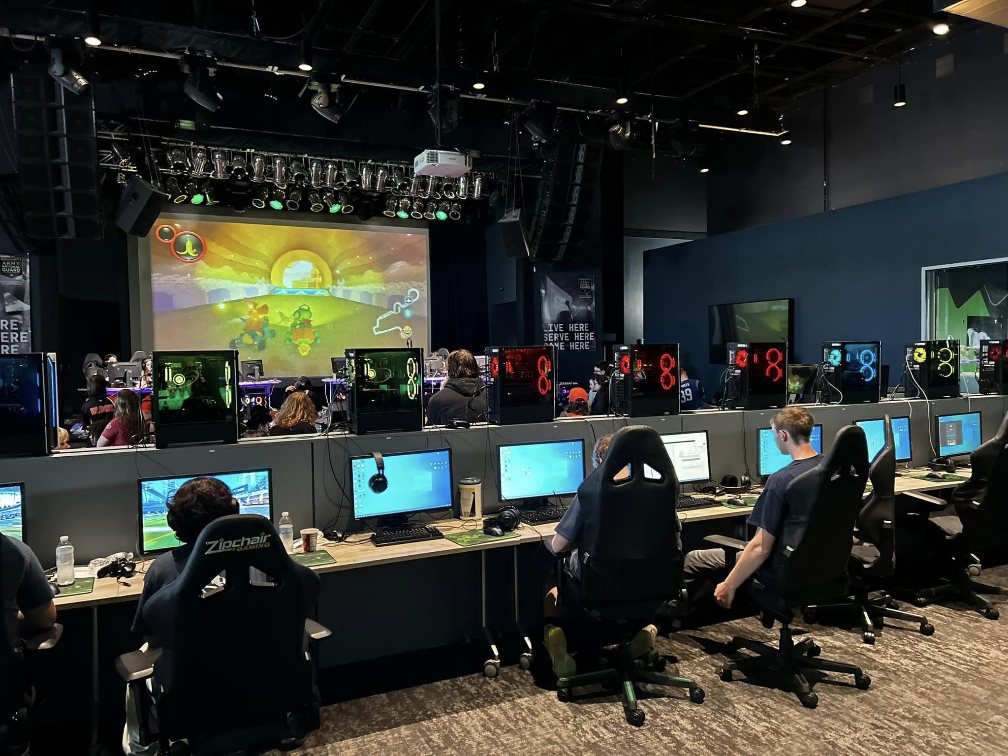 an esport event with people on computers playing a video game together