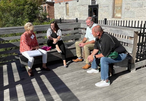 Attendees talking in a small group at the Soul of Leadership conference.